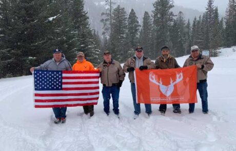 photo-of-group-holding-flag-banner-in-snow-jared-burke-foundation